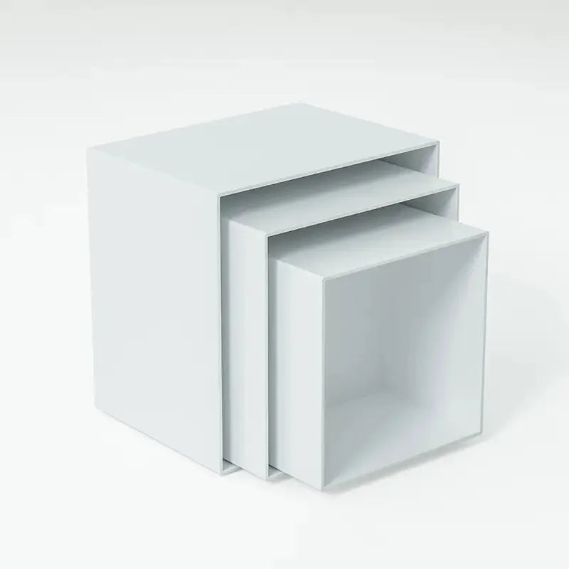 Set of six white plastic tiered dessert display stands arranged on a table.