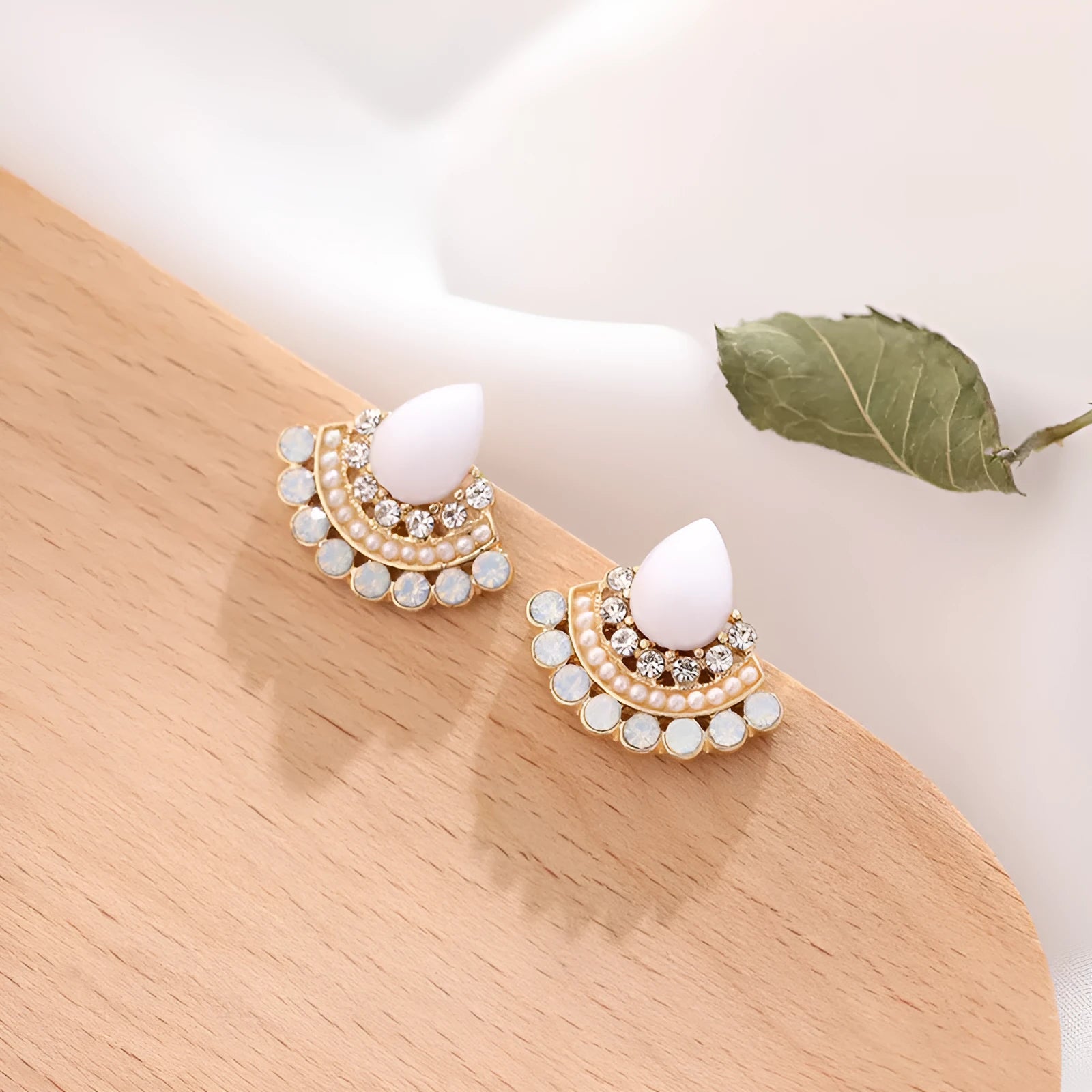 Women's silver retro fan-shaped earrings with an opal-like stone and rhinestone detailing on a geometric alloy setting.