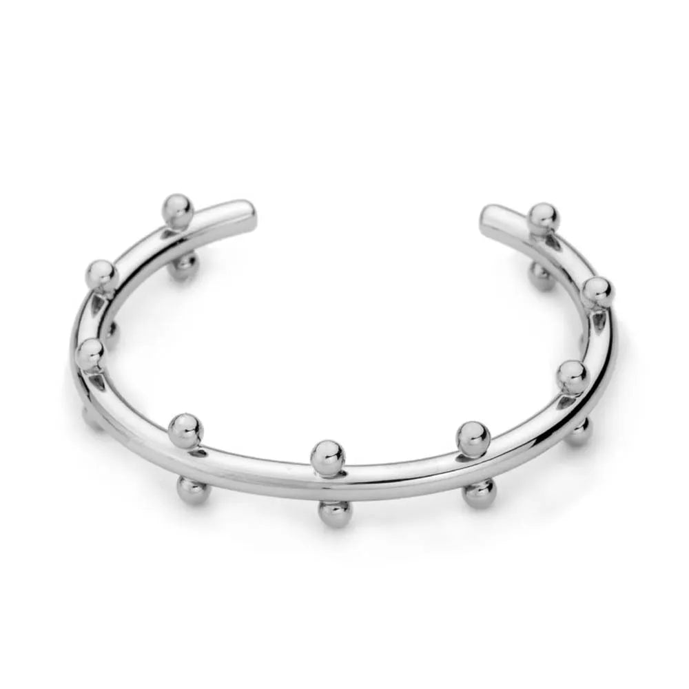 Stainless steel C-shaped bean beads with textured rivet design in gold, steel, and steel gold colours next to an alloy bracelet.
