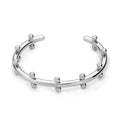 Stainless steel C-shaped bean beads with textured rivet design in gold, steel, and steel gold colours next to an alloy bracelet.