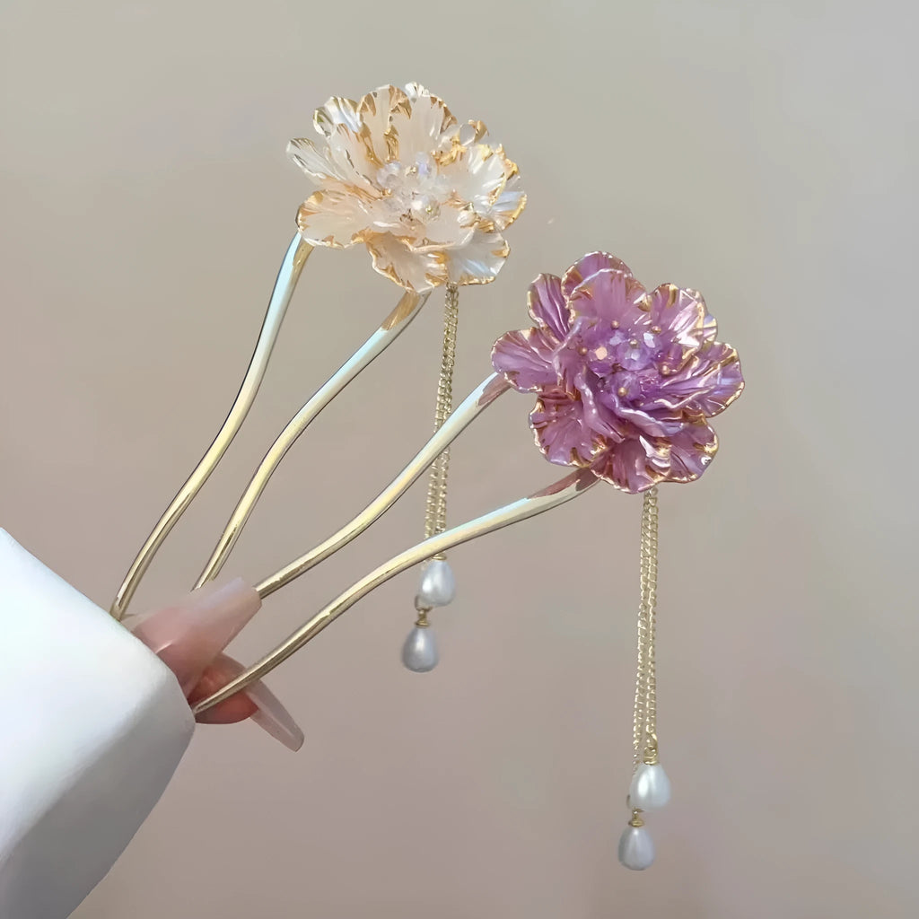Close-up of a purple alloy U-shaped hairpin with a detailed peony flower and tassel design on a white background.