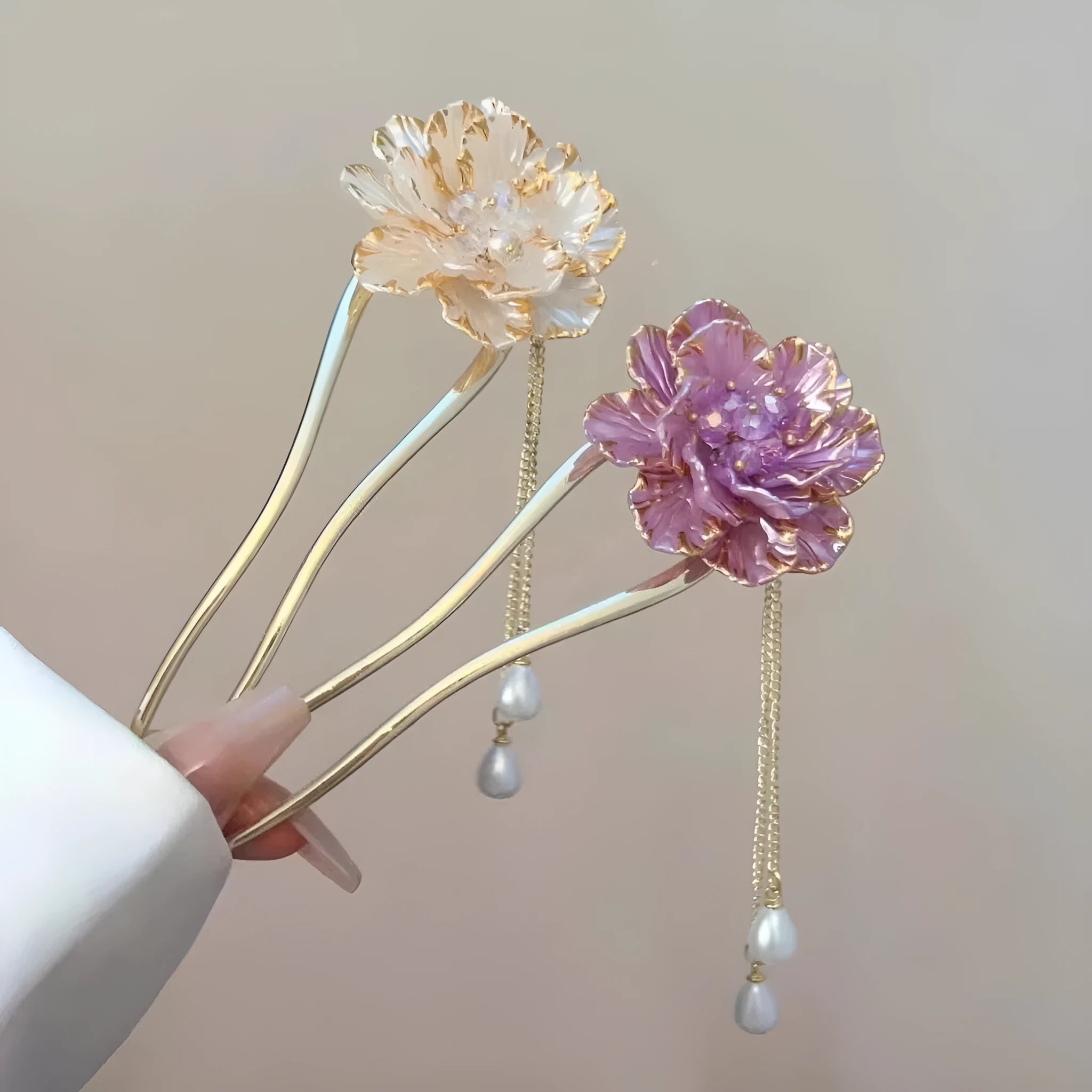 Close-up of a purple alloy U-shaped hairpin with a detailed peony flower and tassel design on a white background.