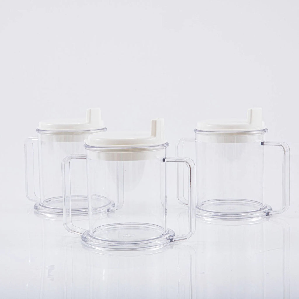Transparent plastic drinking cup with a grey spill-proof lid on a white background.