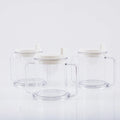 Transparent plastic drinking cup with a grey spill-proof lid on a white background.