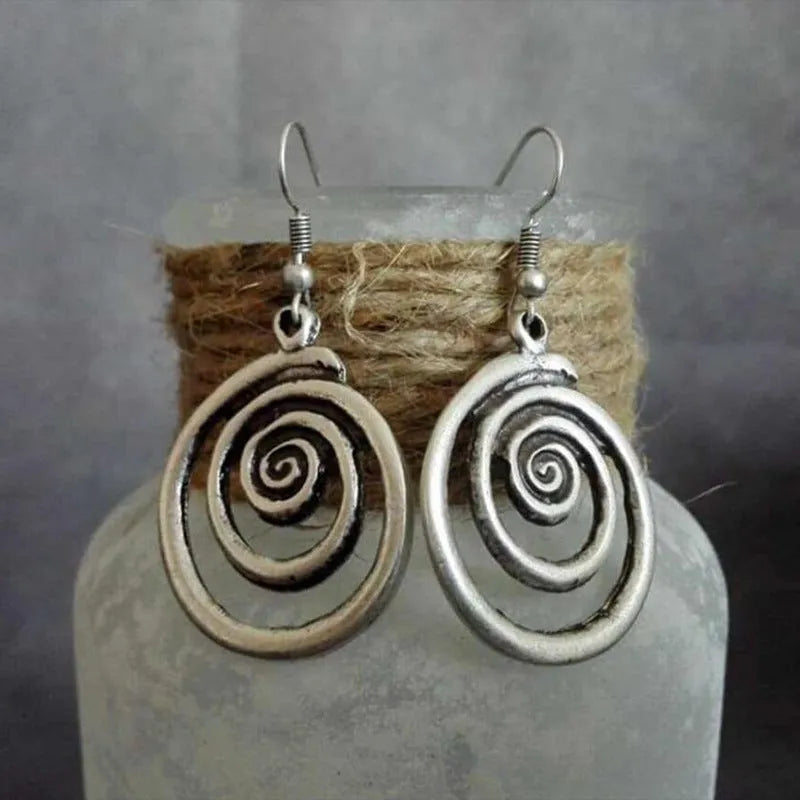 Silver geometric spiral distressed earrings with retro design measuring 2.6 by 5 centimetres