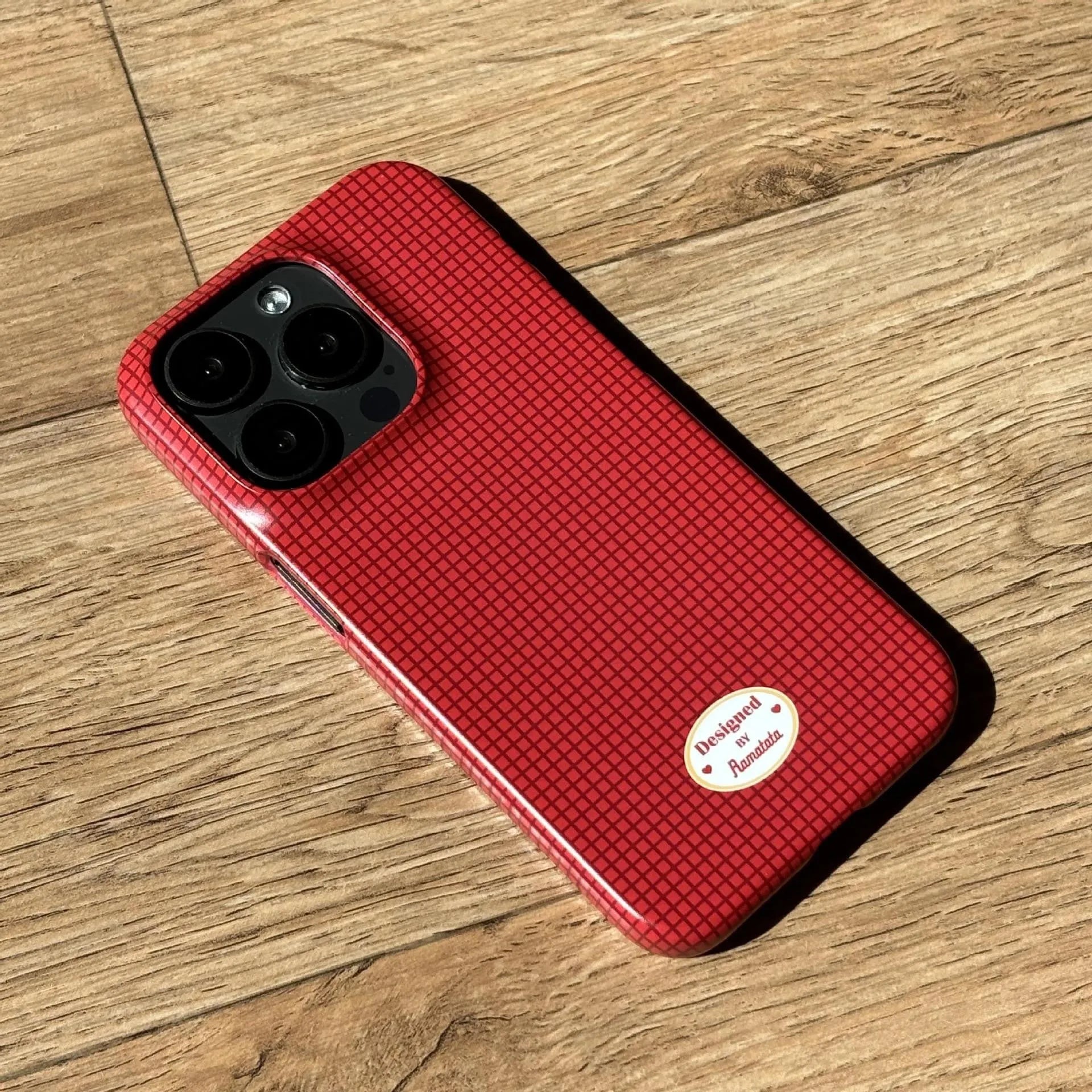 iPhone 15 Pro Max phone case with plaid design in red or orange grid pattern