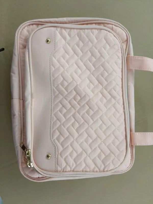 Waterproof polyester hanging cosmetic bag in pink or black measuring 30.5x11x22.9cm