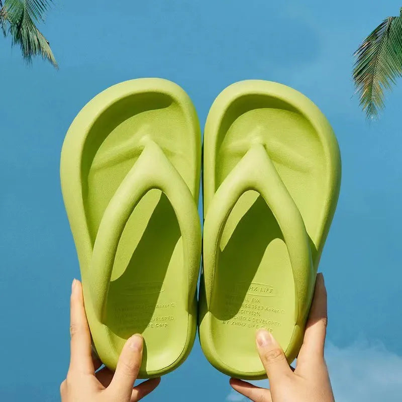 A pair of solid colour thick-soled EVA flip-flops with a bow detail, shown on a light background.