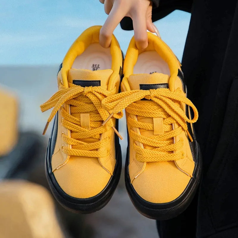 Women's blue and white vulcanised board shoes with a low-top lace-up design and round toe.