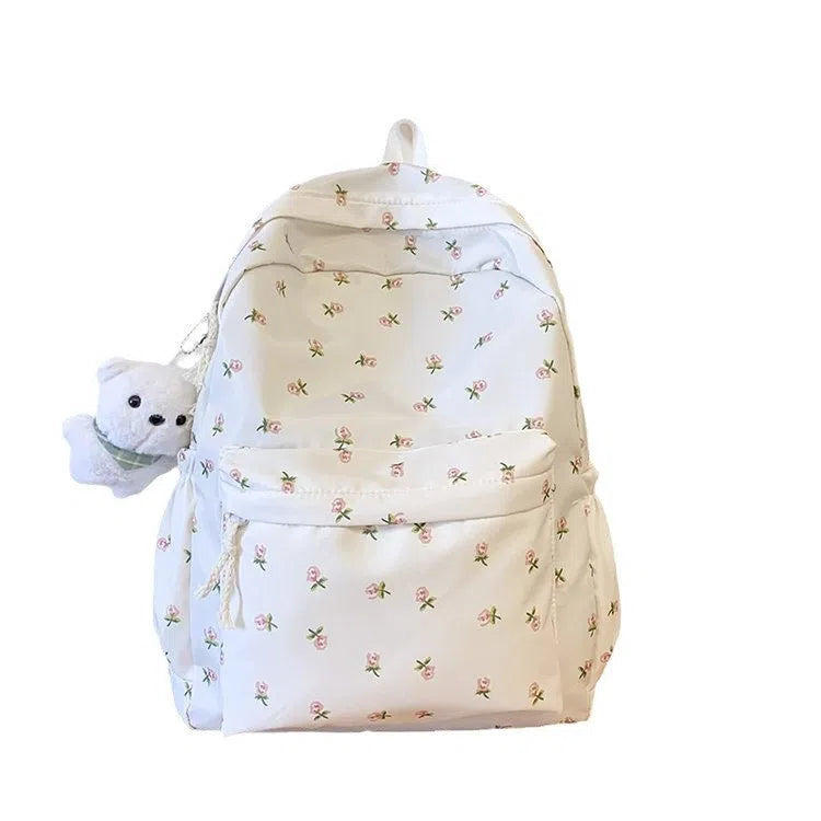 Japanese-style floral print girls' backpack in Oxford cloth with curved shoulder straps, shown in pink floral or white tulip scarf bear.