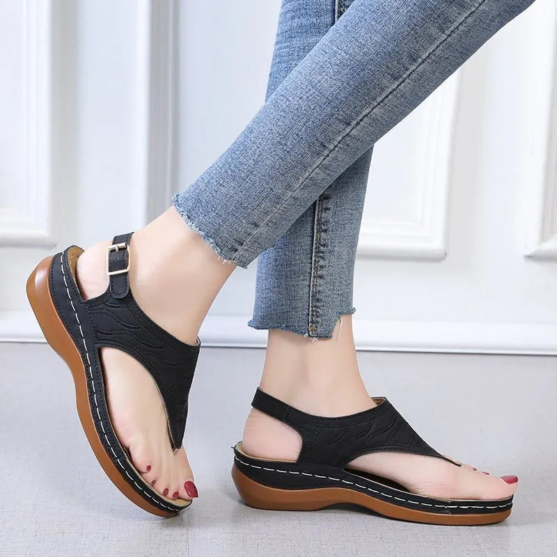 Women's red casual wedge heel sandals with an adjustable buckle strap on a white background.