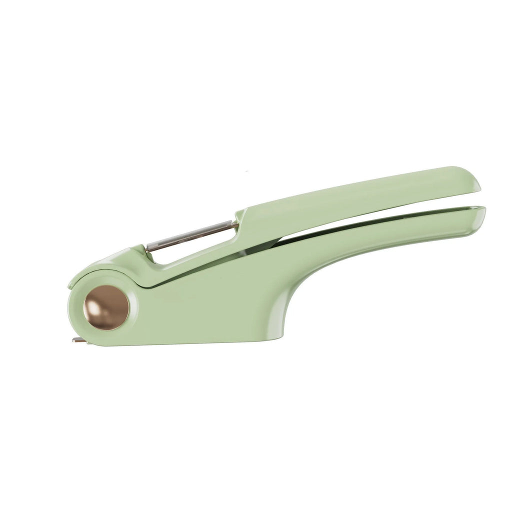 White manual garlic press with stainless steel crusher on a kitchen worktop.