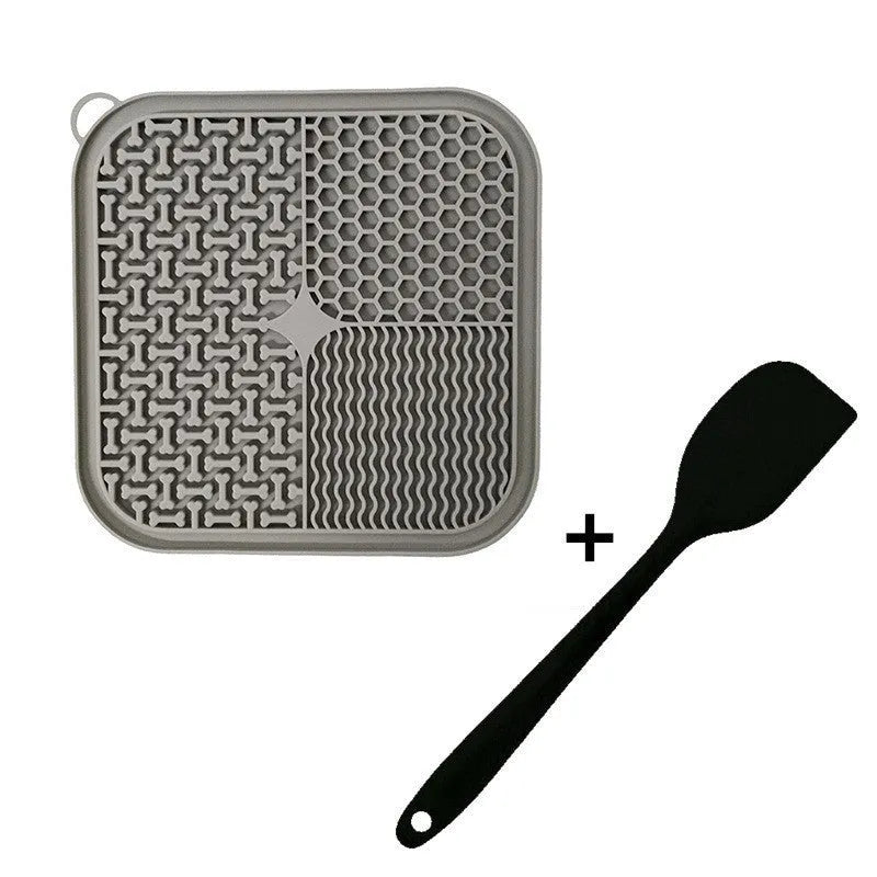 Square orange silicone dog licking mat with textured surface and suction cups on back.