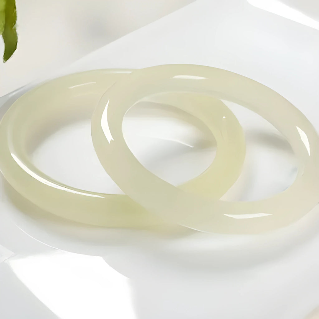 Round bar jade bracelet with winding silk texture showing circular geometry and polished surface