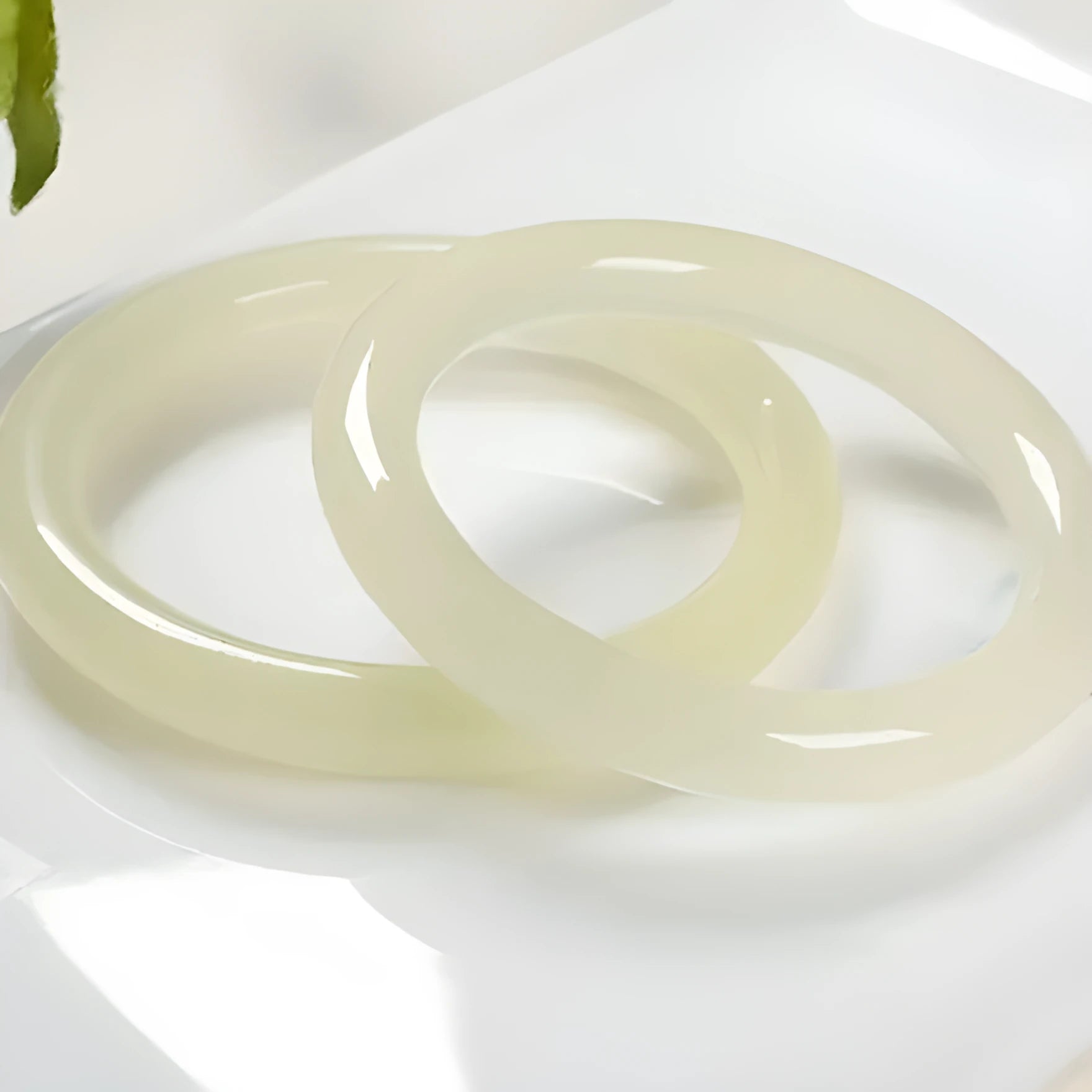 Round bar jade bracelet with winding silk texture showing circular geometry and polished surface
