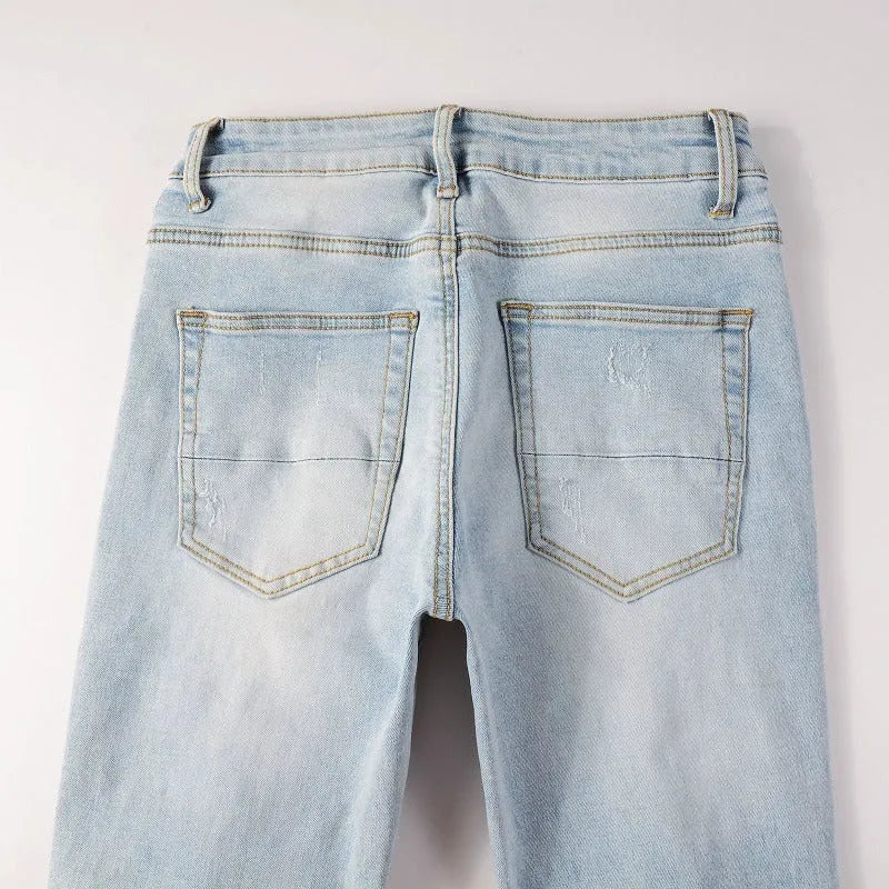 Light blue slim fit stretch jeans for men with hot diamond patch and cat-whisker details