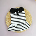 A dog wearing a striped cotton t-shirt and matching skirt summer outfit set.