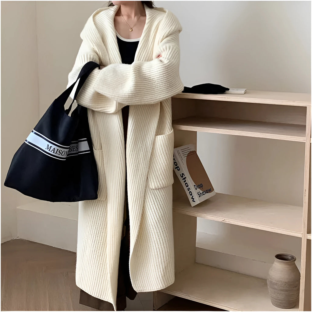 Loose grey hooded cardigan coat for women with long sleeves on a hanger.