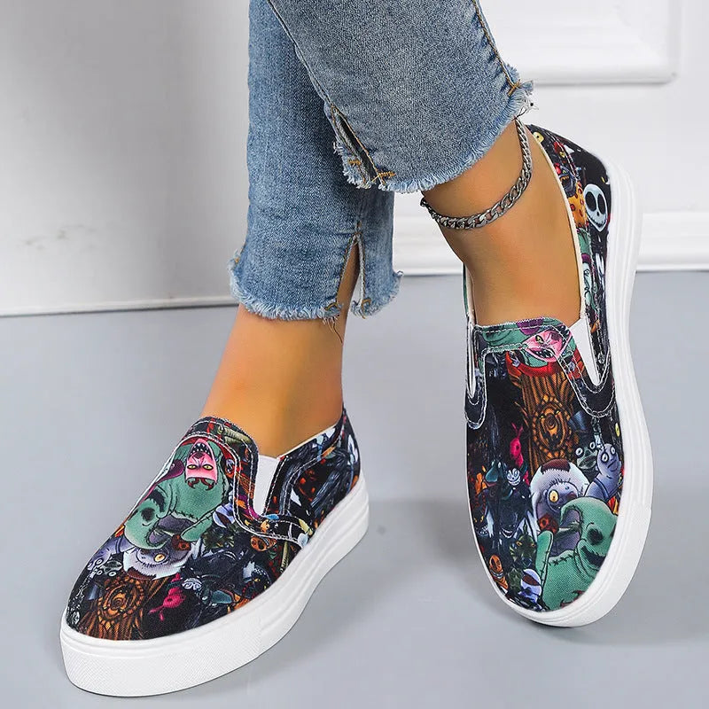 Women's low-top canvas slip-on sneaker in multiple colours, showing flat rubber sole and slip-on design.