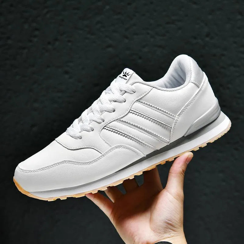 Men's black leather casual running shoes with carved wing pattern and a high heel.