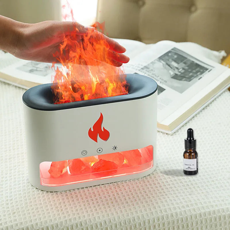 Square white ultrasonic humidifier and aromatherapy diffuser with colourful 3D flame light effect on a desk.