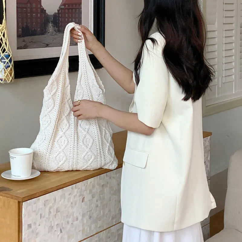 Retro hollow knitted wool yarn women's shoulder tote bag in a solid colour with double straps.