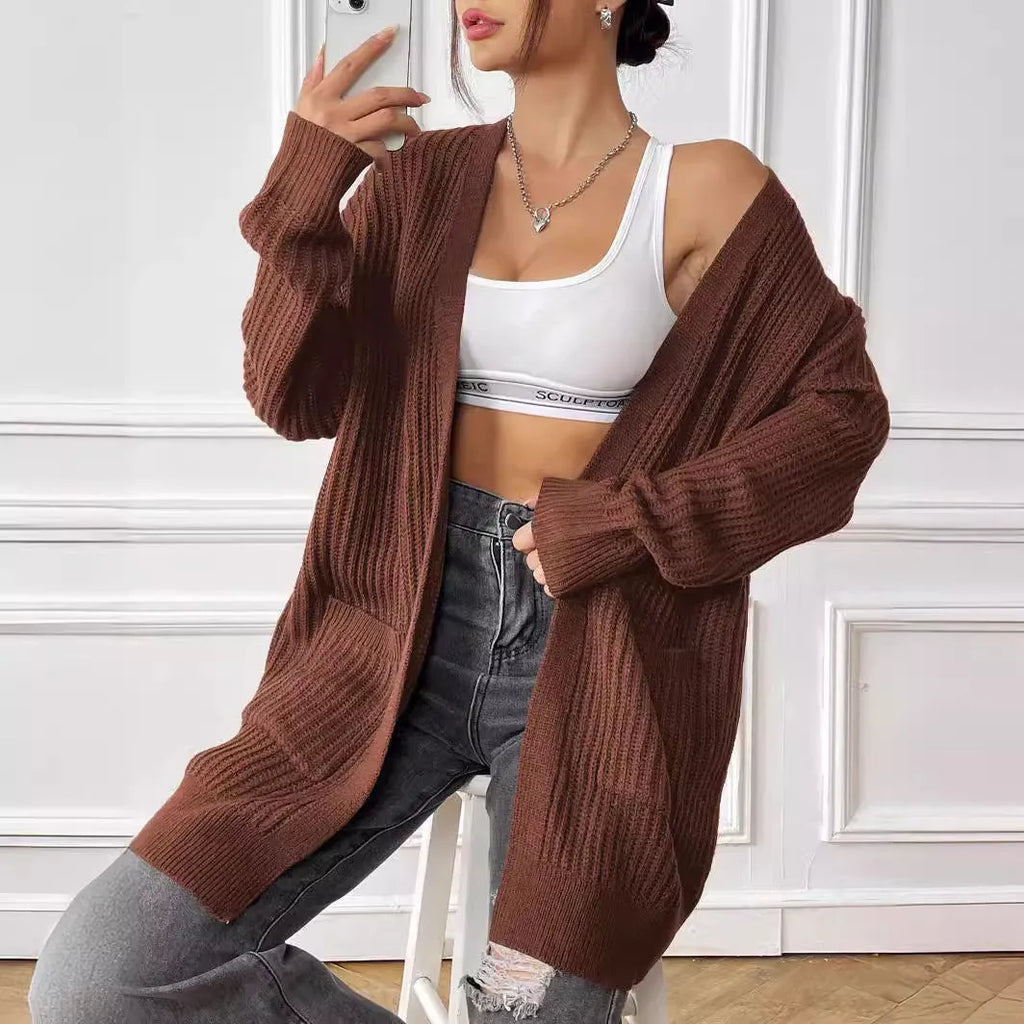 Women's loose fit acrylic cardigan with double pockets in dark green colour showing mid-length design