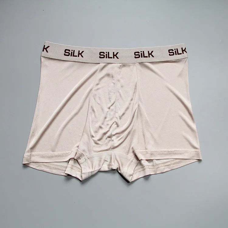 Men's loose fit silk shorts in navy blue, skin colour, and silver grey options with mid-waist design