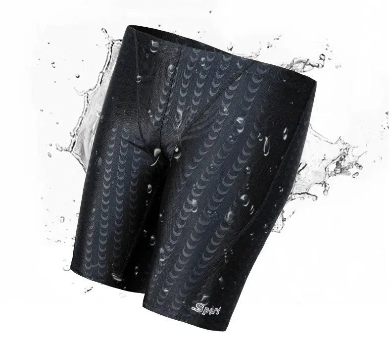 Men's solid colour swimming trunks in shark skin polyester fabric for surfing.