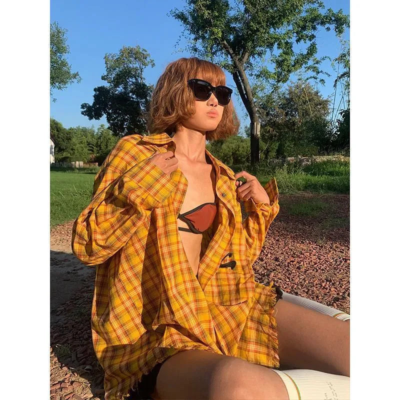 Dopamine yellow and black plaid shirt on a hanger, showing loose fit and cardigan style.