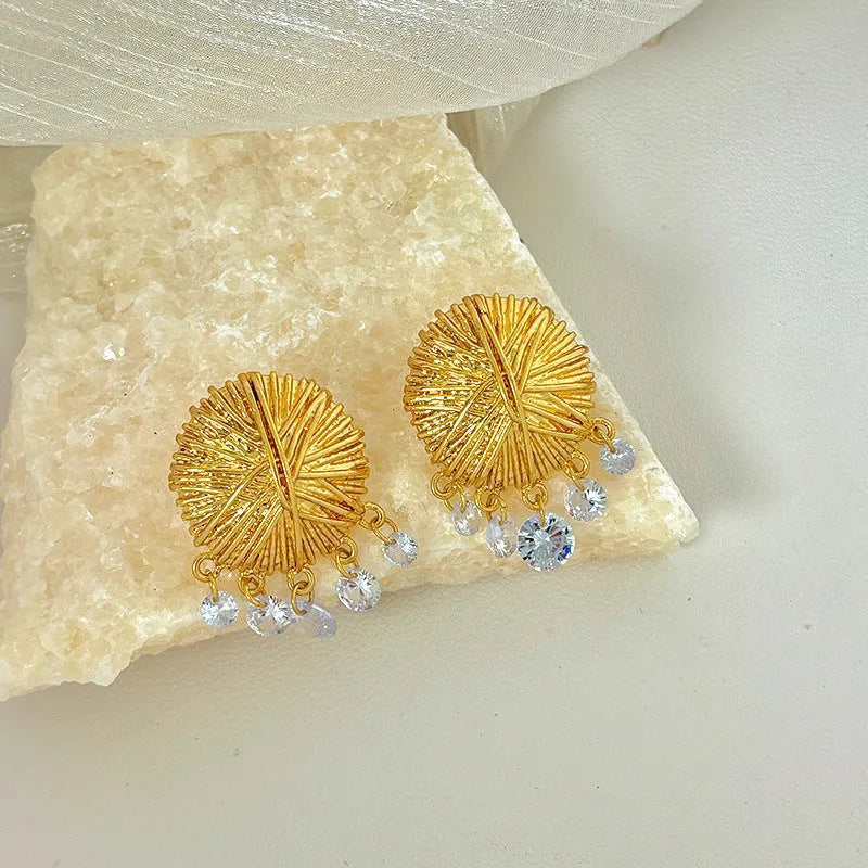 Women's gold geometric hoop earrings with round elements and electroplated finish