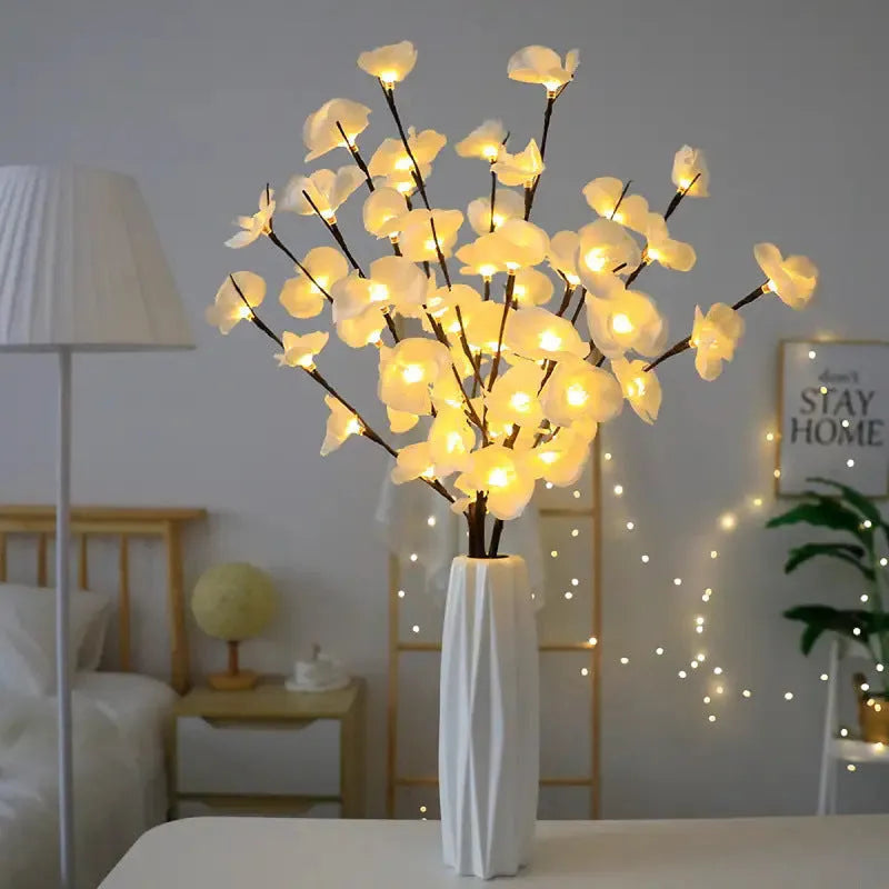 Pink LED phalaenopsis orchid branch decorative light on a table.