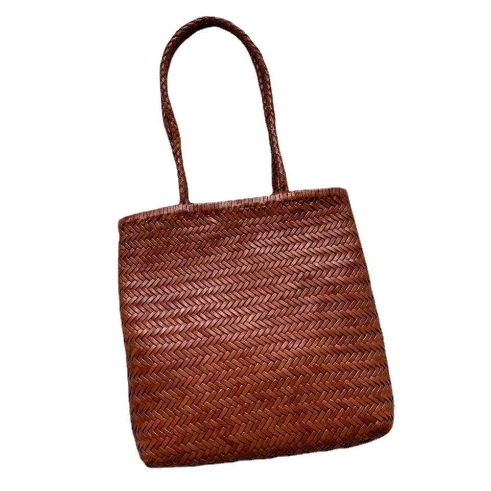 Handmade brown woven cowhide leather tote bag with a structured front pocket.