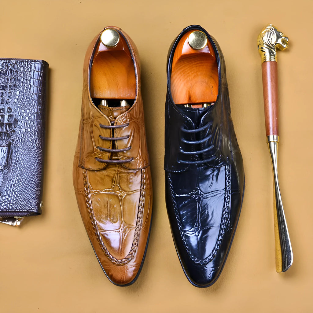 Men's black leather oxford shoes with a horse bit buckle and pointed toe on a rubber sole.