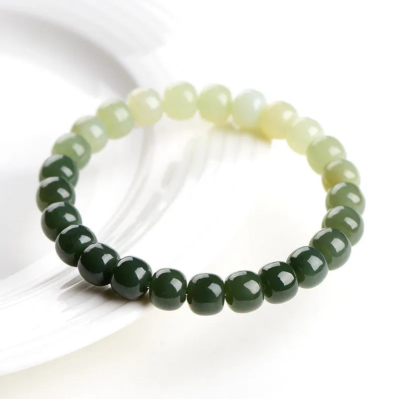 Polished Hetian jade bracelet with clear water gradient colour on wrist.