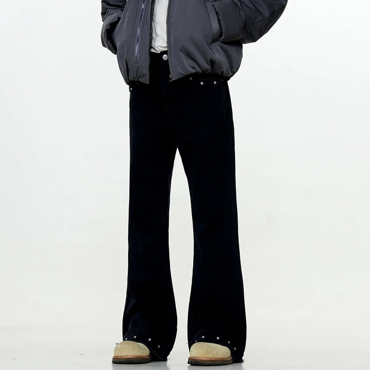 Straight-leg cotton jeans on a hanger, showing mid-waist fit, zipper fly, and horn-style leg opening.