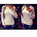 White women's hollow-out knitted long sleeve shirt with round neck on a hanger.