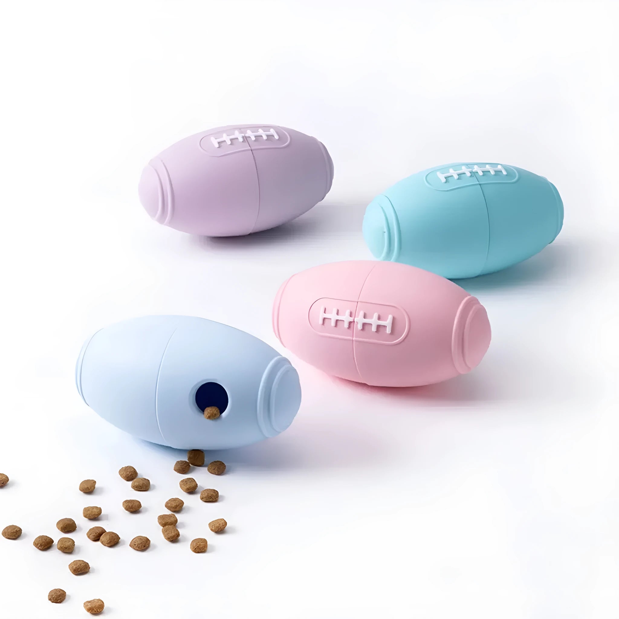 Coloured silicone rugby ball dog chew toy with treat-dispensing holes in blue, pink, purple options