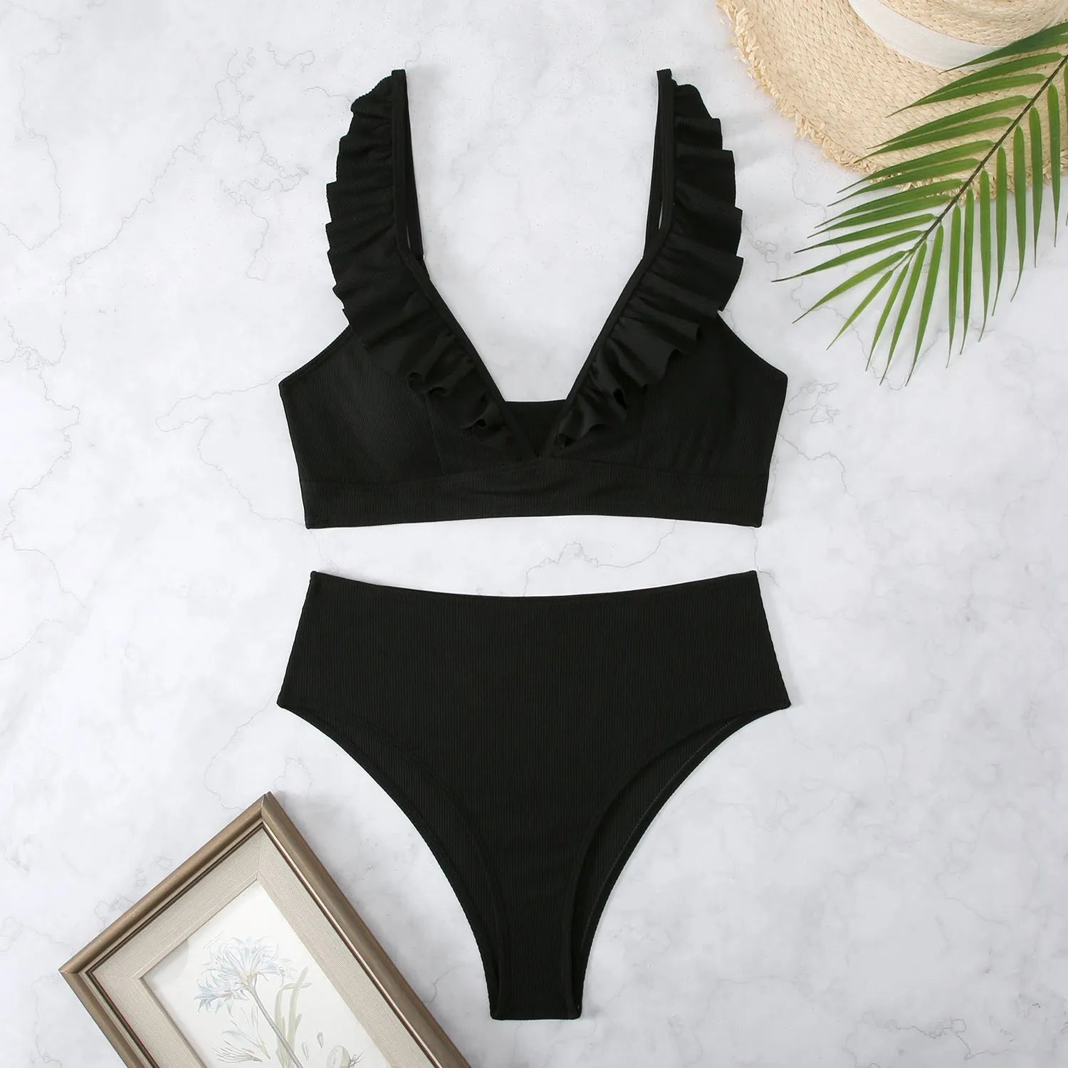 Women's black and white striped bikini with split chest design on a mannequin.