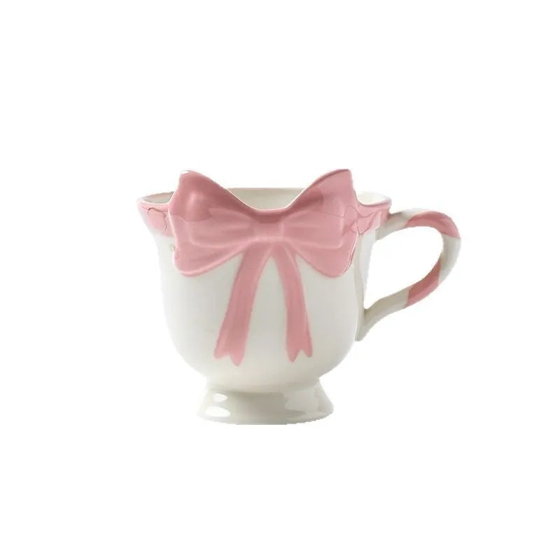 White ceramic mug with heart and bow design, 301-400ml capacity, bow-shaped handle