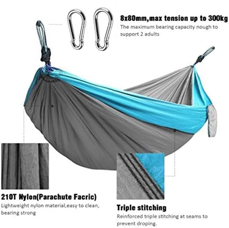 Blue nylon parachute cloth camping hammock hung between two trees outdoors