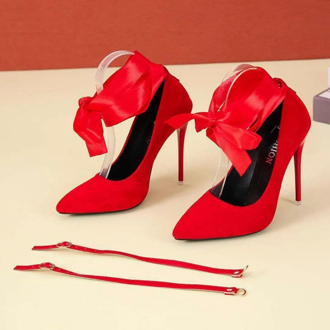 Black and red pointed toe high heels with thin straps and a shallow mouth, shown with flat buckle.