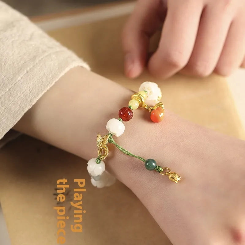 White jade Bodhi bracelet with hand-woven rope, lotus beads, and large pumpkin beads on an open ring design.