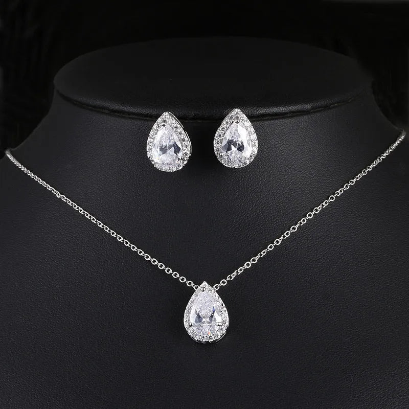 Women's water drop gemstone necklace and earrings set in copper with zircon on white background