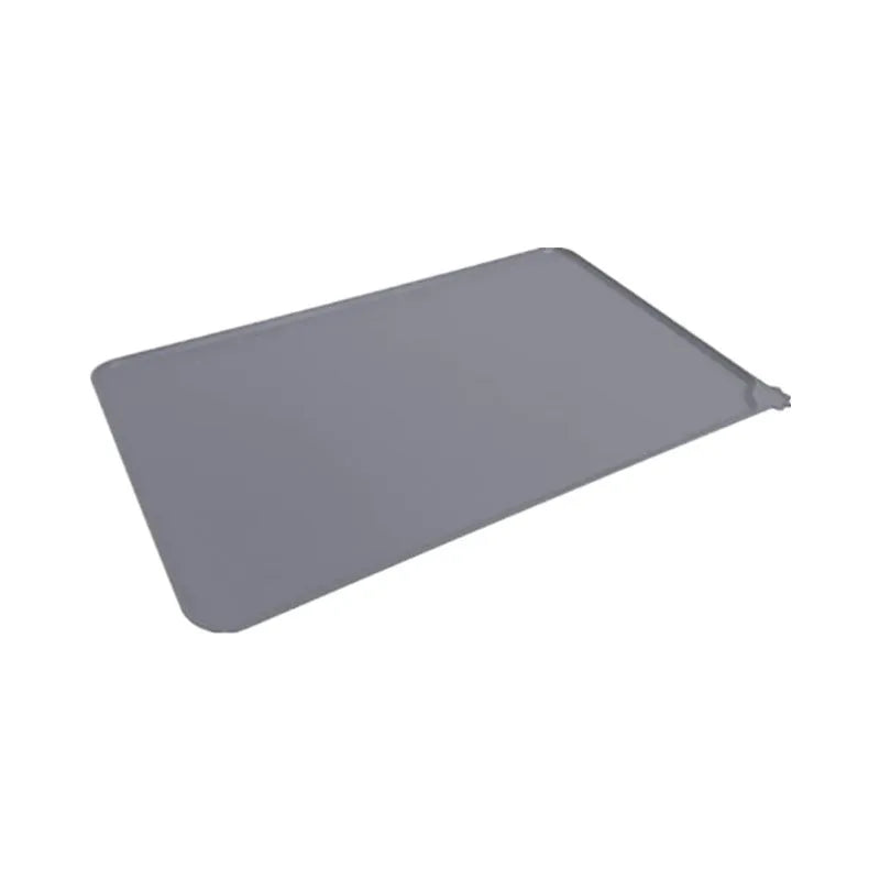 Silicone pet placemat under a dog bowl in grey colour on a kitchen floor.