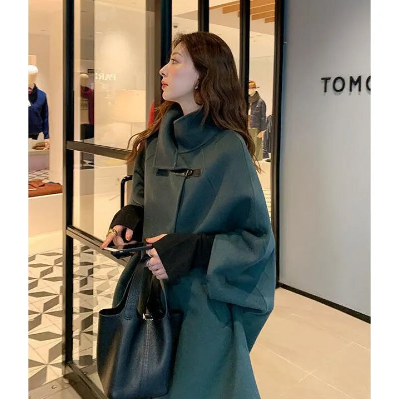 Korean-style women's long coat in oatmeal colour with flight sleeves, shown on a model.