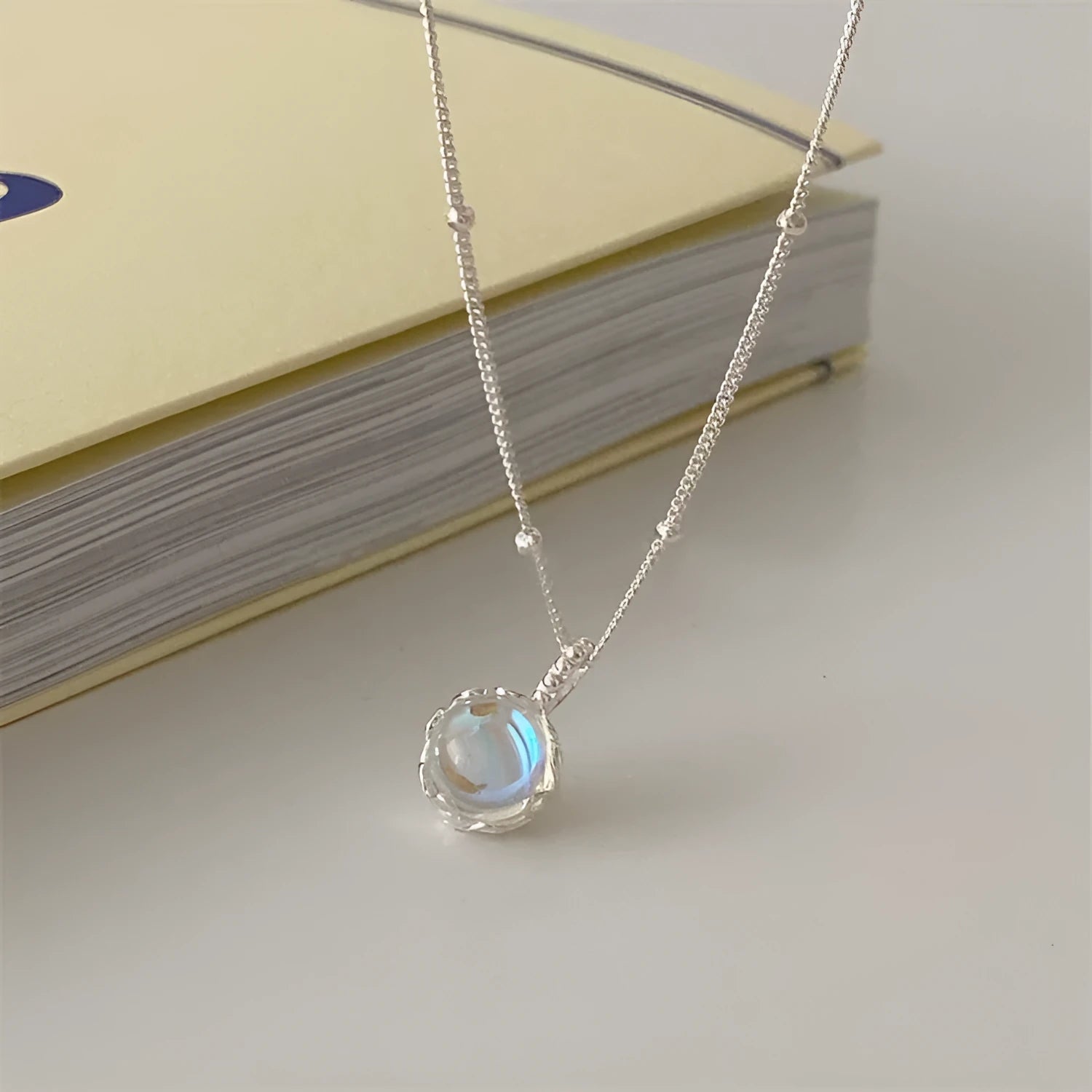 Silver 925 ornamental necklace with round geometric pendant on a curb chain, adjustable length.