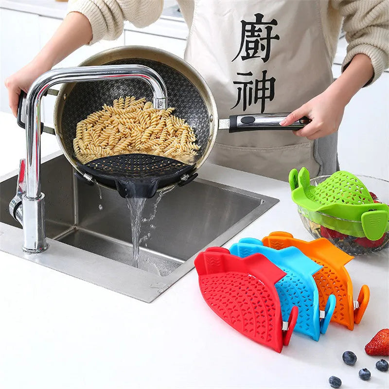 Silicone and stainless steel pot side drain stopper in multiple colours on a kitchen counter.