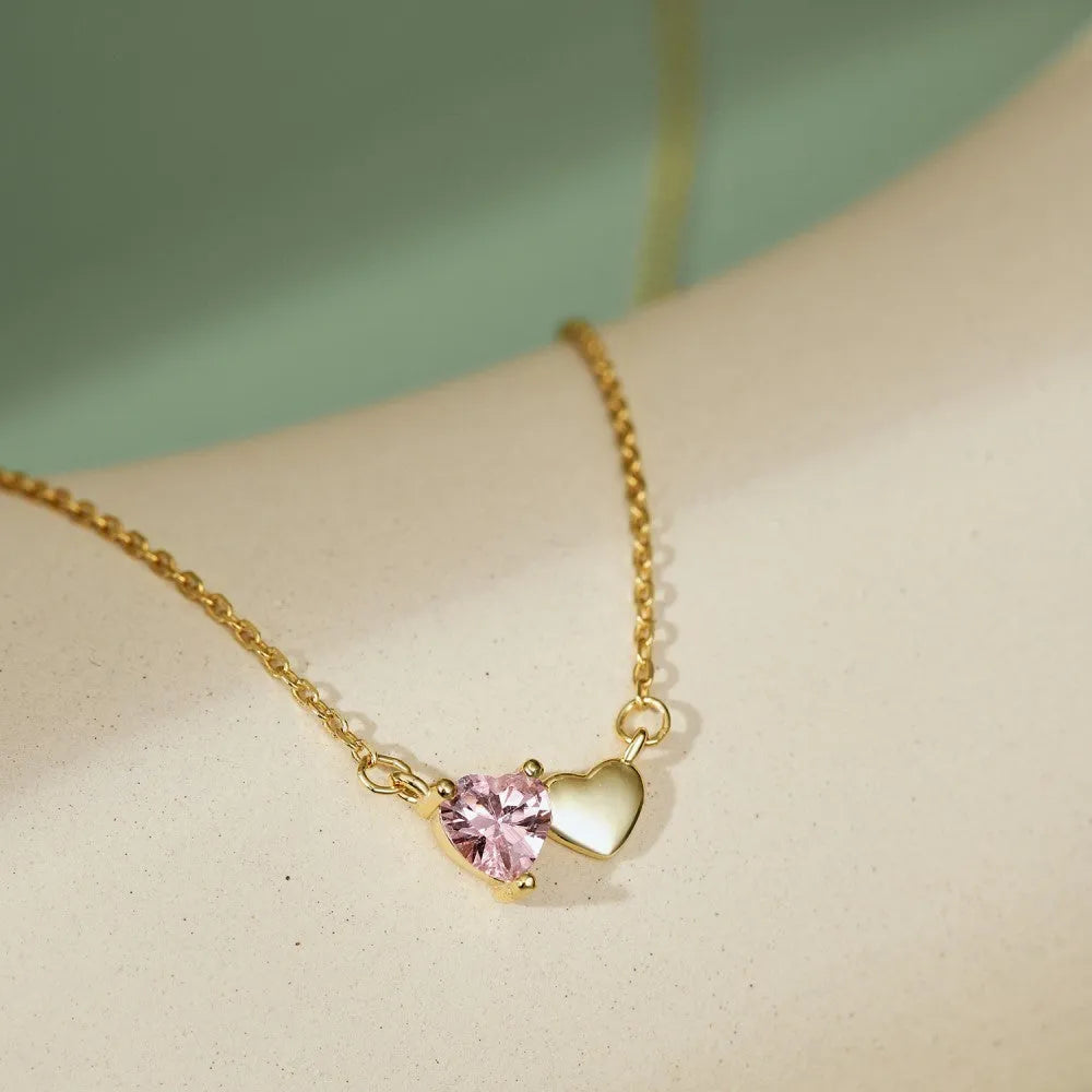 925 silver heart necklace with emerald zircon in gold finish on display