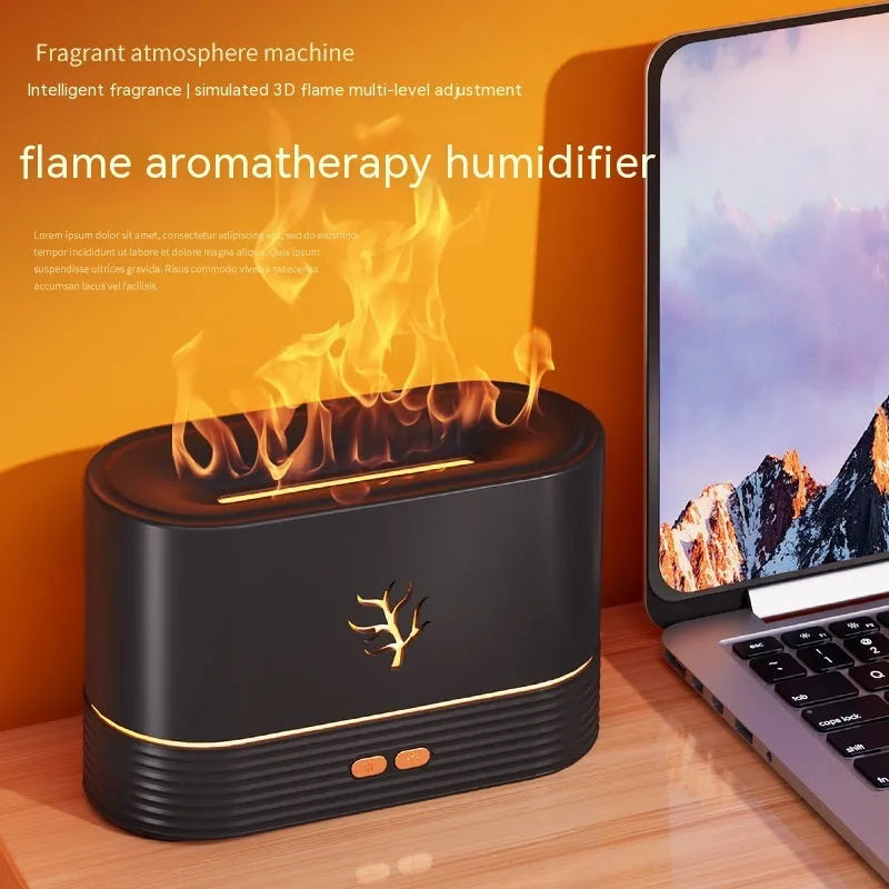 Black square USB aroma diffuser with LED flame light effect and mist output on a wooden table.